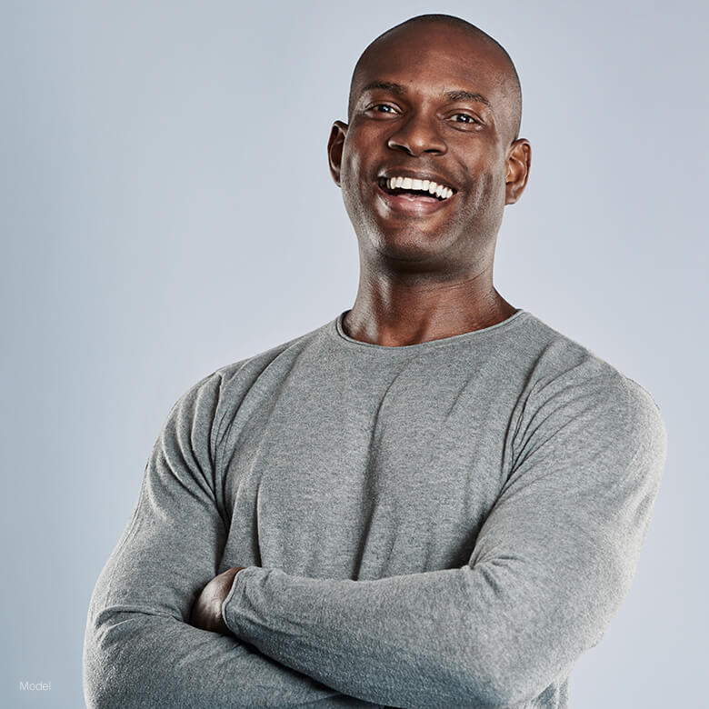 Handsome man in gray smiling